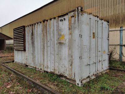 un conteneur blanc posé au milieu d'une voie ferrée