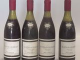 four bottles of wine are lined up on a table
