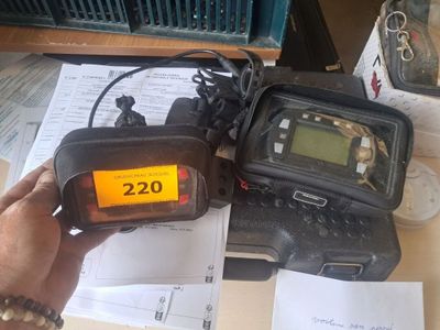 a person holding a radio that is sitting on a table