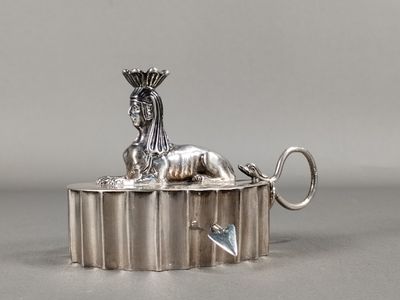 an image of a silver statue of a lion with a crown on it ' s head