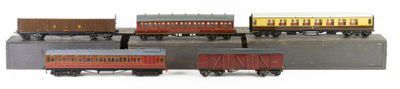 several toy trains are lined up next to each other on a white surface