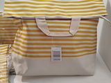 a yellow and white striped bag on a table