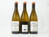 trois bouteilles de vin posées l'une à côté de l'autre sur une table