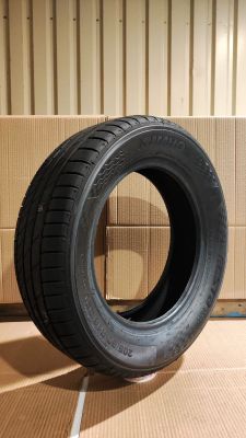 tire on the floor next to a cardboard box in a warehouse