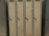 several metal lockers are lined up in a row in a warehouse