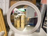 a mirror that is sitting on a table in a room