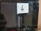 someone is taking a picture of a microwave with the number 4 on it