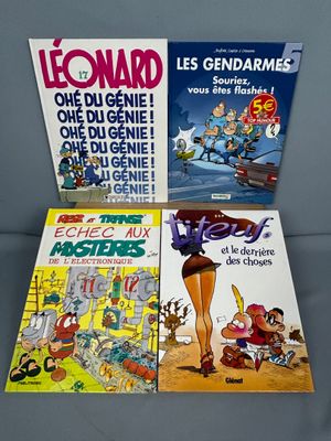 trois livres posés sur une table, dont l'un représente un personnage de bande dessinée et l'autre est une bande dessinée