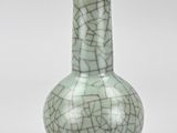 a green vase that has a cracky design on it