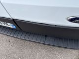 a close up of the front bumper of a white truck