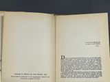 an open book on a table with a black background