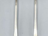 pair of silverware spoons and spoons with a face on them