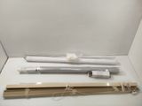 a white box with a light and a wooden stick in it