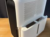 an air purifier sitting on top of a wooden table