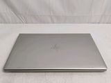 a laptop that is sitting on a white surface