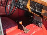dashboard of a car with red leather seats and a steering wheel