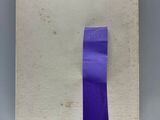 a piece of paper with a purple tape on top of it