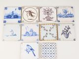 several blue and white tiles with pictures of birds and flowers on them