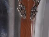a silver vase that is sitting on a table