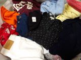 a pile of clothes that is sitting on a couch