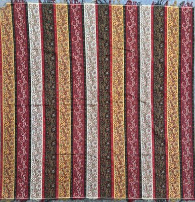 a close up of a red, yellow and brown striped rug