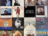 many different album covers on the wall of a room