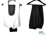 two black and white vests hanging on a hanger