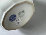a cup and saucer sitting on a table next to a plate
