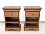 a pair of wooden bedside tables with drawers on each side