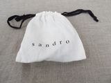 a white bag with the word sandro written on it