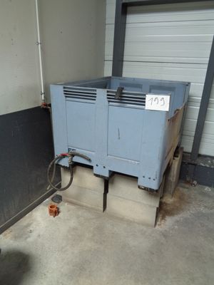 a blue air conditioner sitting in a garage