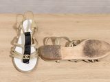 pair of women ' s sandals on a wooden table with a white background