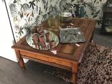 a wooden table with a glass vase on top of it