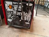 a machine that is sitting on the ground in front of a building
