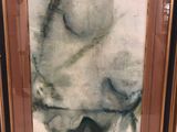 painting of a sheep in a frame on display in a store