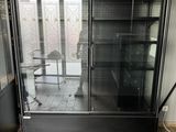 une vitrine en verre dans le coin d'une pièce