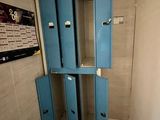 two blue lockers in the corner of a room