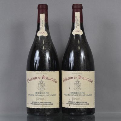two bottles of red wine sitting on top of a table