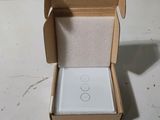 a box with a white button on it sitting on a table