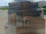 a dog sitting in a box wrapped in plastic