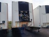 two large trucks that are parked in a lot