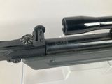 a gun that is on display in a glass case
