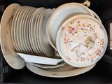 a stack of plates and bowls in a black box