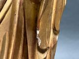 gold statue of a woman holding a baby in her arms