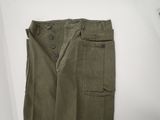 a close up of a pair of olive green pants on a white surface