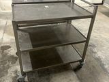 a metal cart that is sitting in the middle of a room