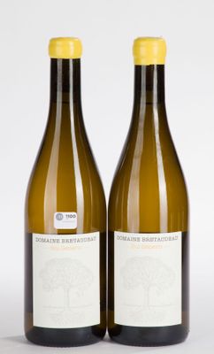 two bottles of wine sitting next to each other on a white surface