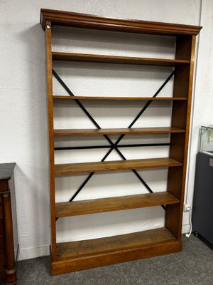 une bibliothèque en bois à quatre étagères, placée dans un coin de la pièce