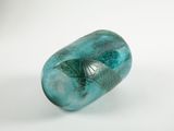 a blue glass vase with a green design on it