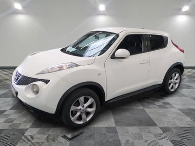 a picture of a white nissan suv parked in a garage